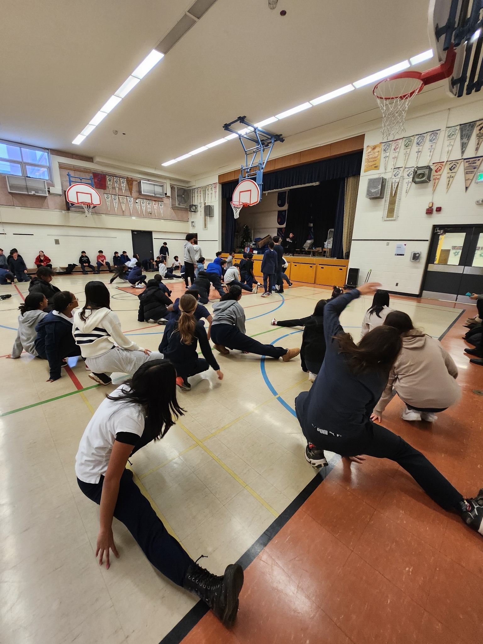 Students taking part in a Cypher dance session in a school gym